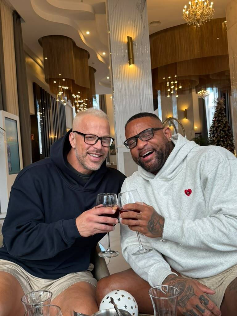 Shaun T and Scott Blokker raising a glass of wine